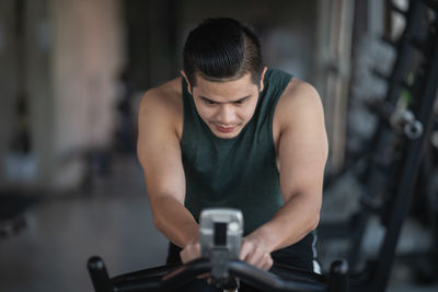 Young man exercising at gym