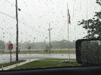 Road seen through wet car window