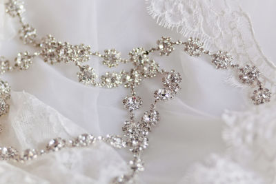 Close-up of necklace on wedding dress