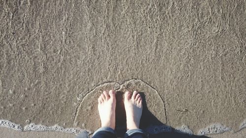 Low section of woman standing on tiled floor