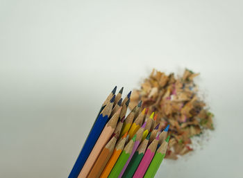 Close-up of colored pencils against white background