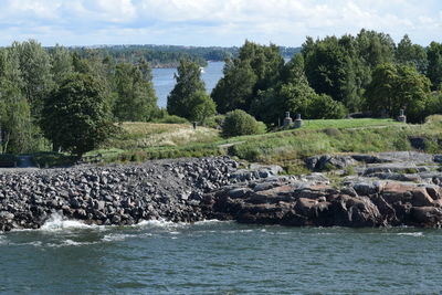 Scenic view of rocks in sea against sky