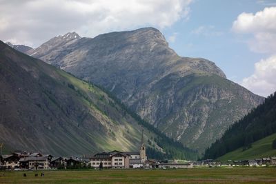 Scenic view of houses and mountains against sky