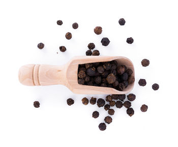 High angle view of coffee beans against white background