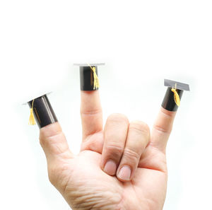 Close-up of hand holding bottle against white background