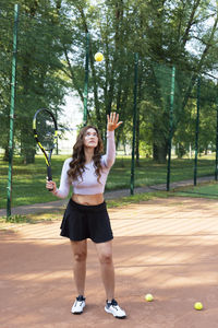 Full length of young woman exercising in park