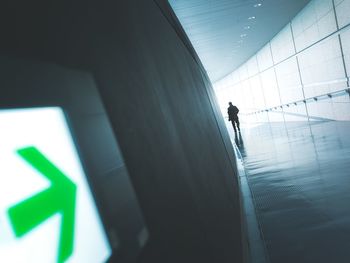 Close-up of arrow symbol in illuminated tunnel