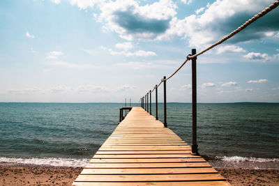 Pier over sea against sky