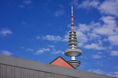 Low angle view of communications tower against sky