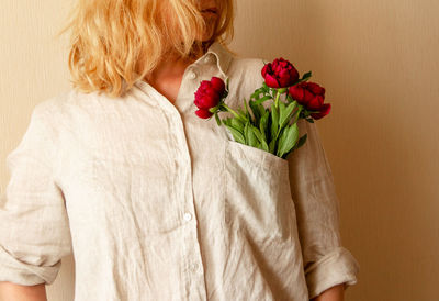 Rear view of person holding rose bouquet