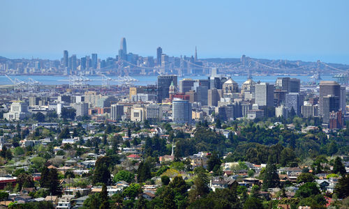 Aerial view of buildings in city against clear sky