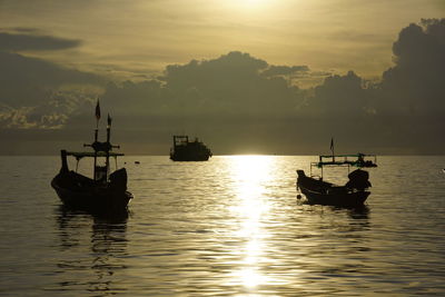 Boat sailing in sea at sunset