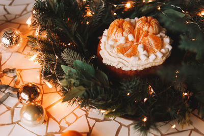 Christmas background. christmas food. cakedecorated with tangerines and fir branches in the holidays