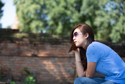 Side view of young woman looking away outdoors