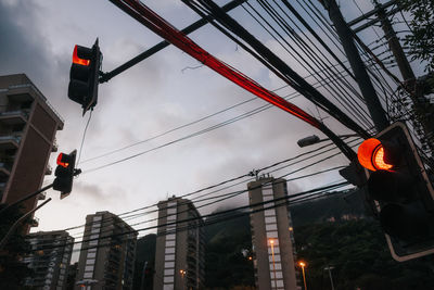 Low angle view of road signal against sky