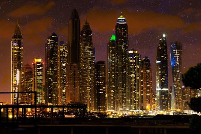 Illuminated modern buildings in city at night