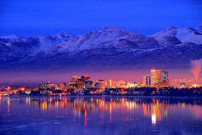 Illuminated buildings in lake