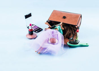 High angle view of personal accessories on blue background