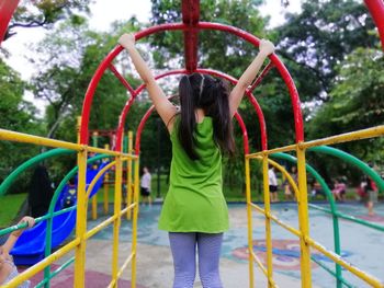 Rear view of girl playing at playground