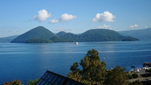 Scenic view of sea and mountains against sky