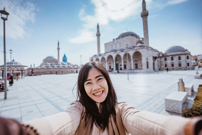 Portrait of young woman in city