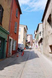 Street amidst buildings against sky