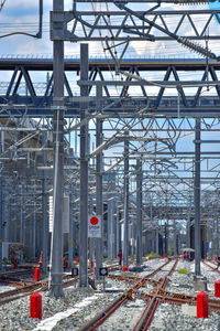 Railroad tracks in city against sky