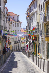 Empty alley amidst buildings in city