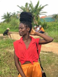 Side view of young woman standing on field