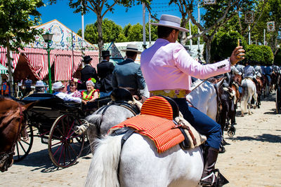 Rear view of woman riding horse