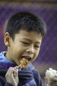 Close-up of boy eating food