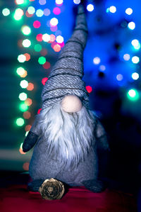 Low angle view of woman holding illuminated string lights