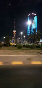 Illuminated city street and buildings at night