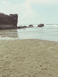 View of calm beach against sky