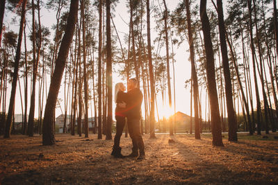 Happy young couple in love looking each other face to face at sunset