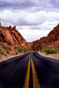 Road against rock formation and sky