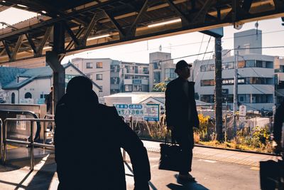 Rear view of silhouette man walking in city