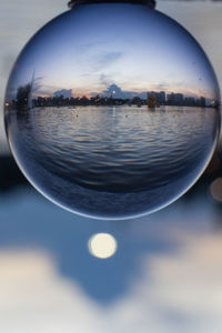 Scenic view of lake against sky seen through glass