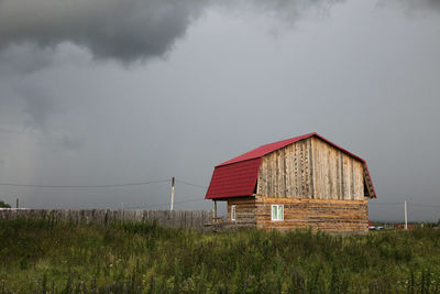 House on field against sky