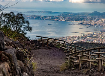 High angle view of townscape harbor by sea against sky bay of napoli naples