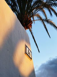 Low angle view of road sign against sky