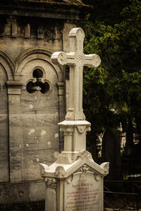 Sculpture in cemetery against building