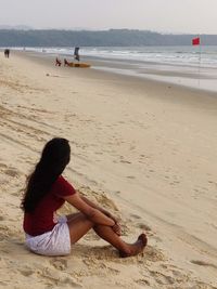 Woman sitting on beach