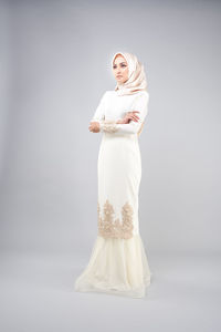 Woman standing against white background