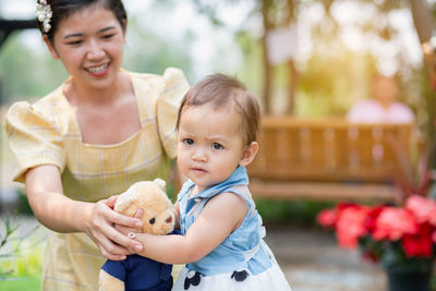 Portrait of happy mother holding baby boy