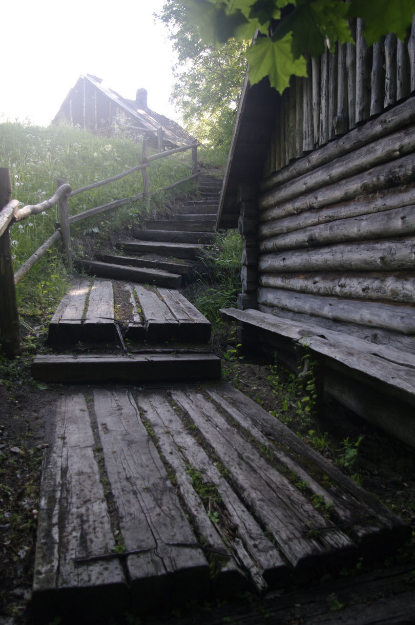 ABANDONED BENCH AGAINST BUILDING