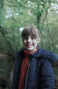 Portrait of smiling girl standing outdoors