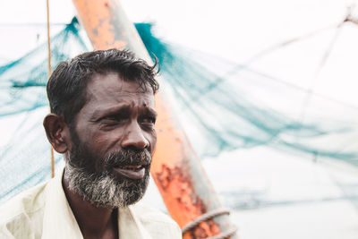 Close-up of fisherman looking away