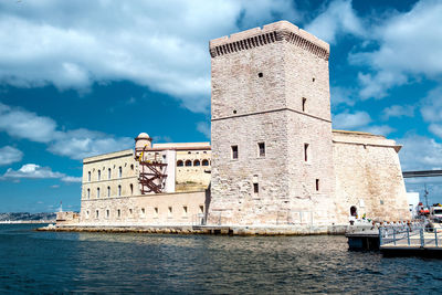 Low angle view of historical building against cloudy sky