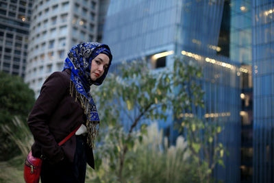 Young woman looking away in city